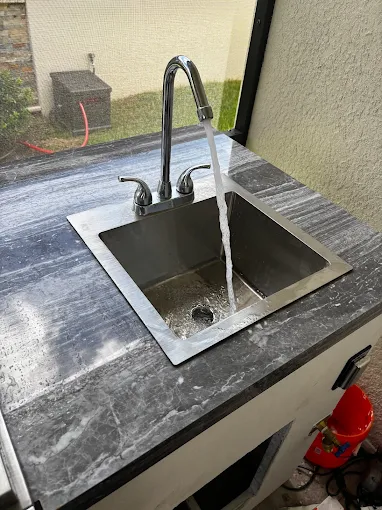 Modern kitchen sink faucet with running water installed by Kabam Plumbing Services